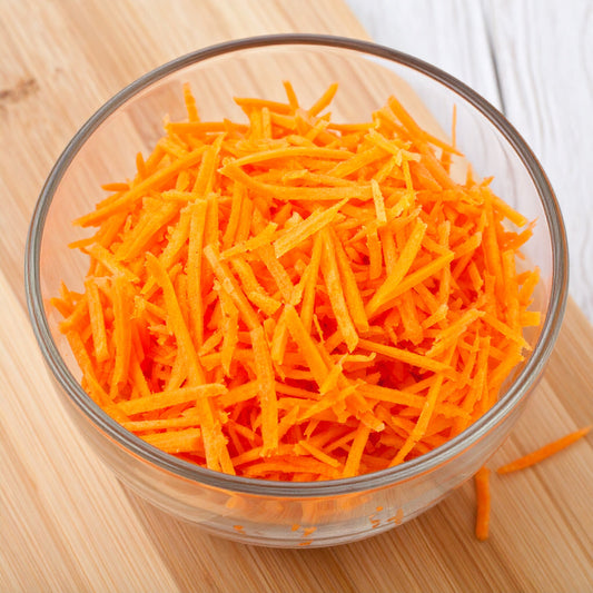Grated Carrots in a Glass Bowl