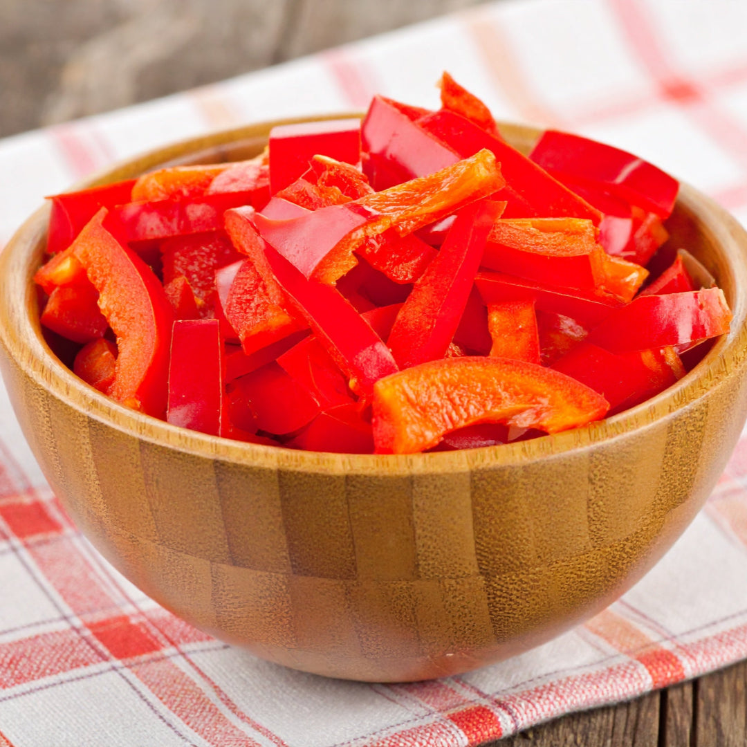 Red Sliced Capsicum in a Wooden Bowl