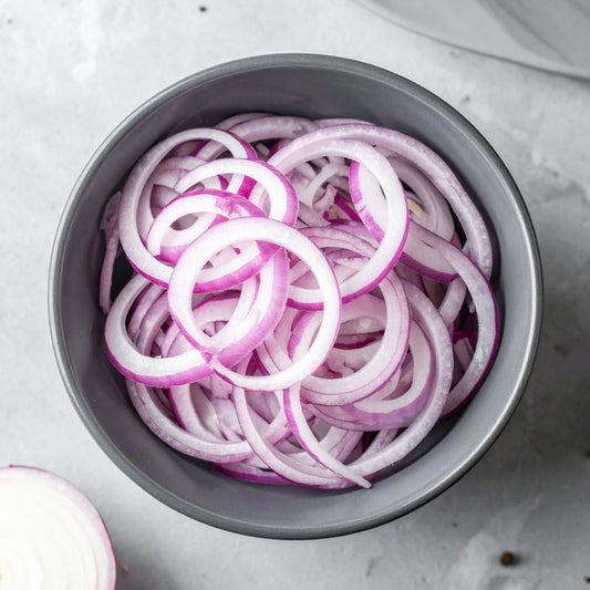 Sliced Red Onion in a grey ceramic bowl