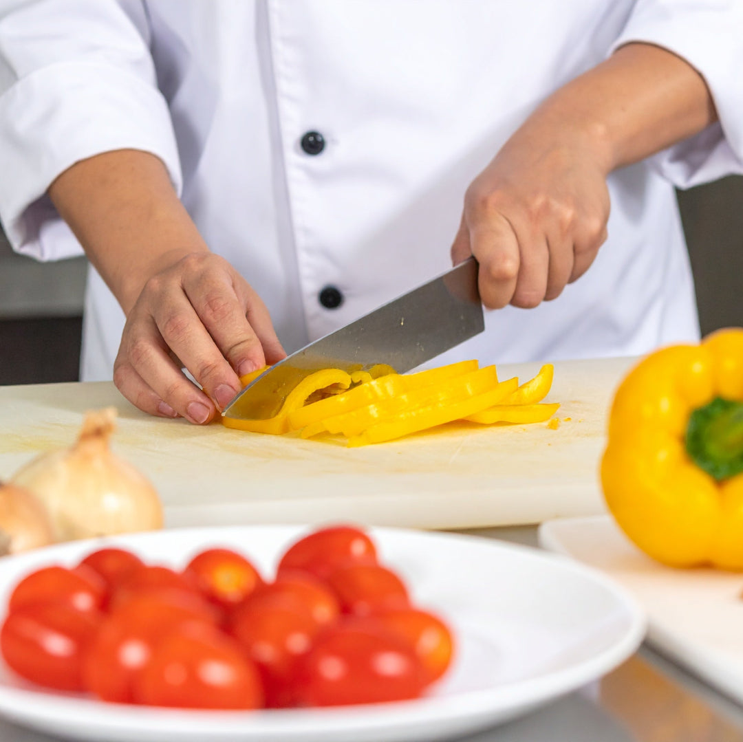 Chef slicing a yellow capsicum Julienne