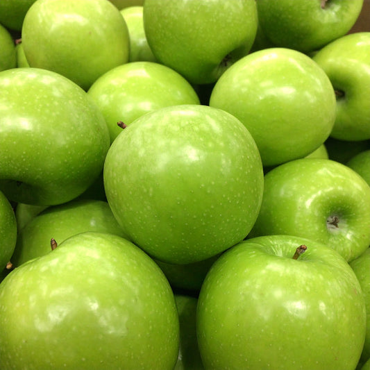 Close-up of a pile of green apples