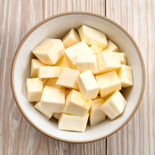 Diced Parsnip in a Cream bowl on a wooden table