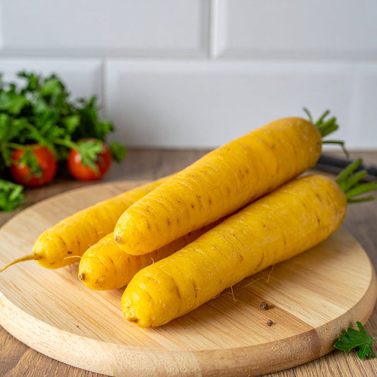 Large Yellow Carrots on a circular wooden chopping board