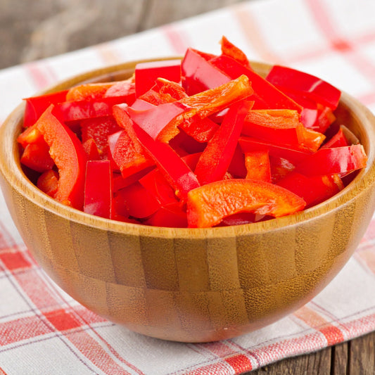 Red Sliced Capsicum in a Wooden Bowl
