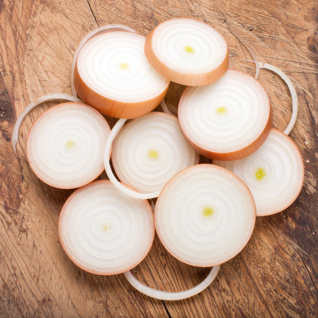 Sliced Brown Onions on a wooden table