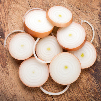 Sliced Brown Onions on a wooden table