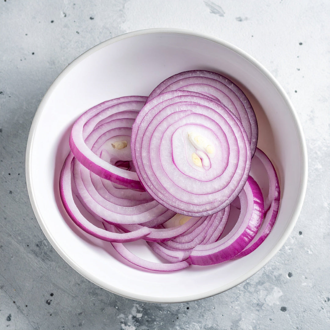 Sliced Red Onion in a white bowl